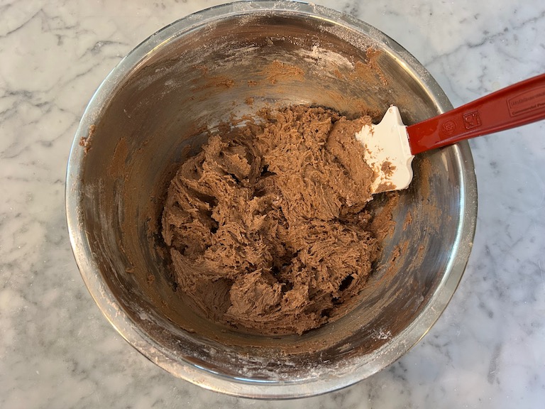 Chocolate cookie dough in a bowl with a spatula