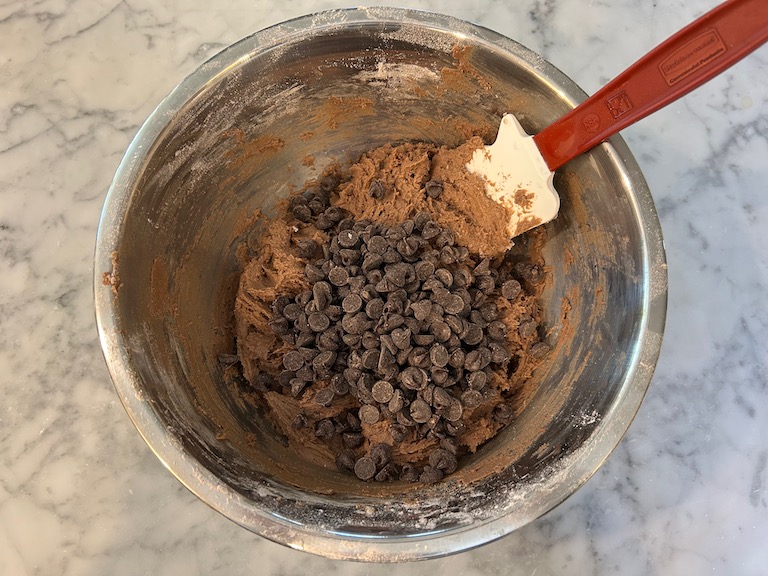 Chocolate chips in a bowl of chocolate cookie dough