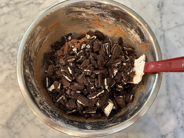 Stirring chopped Oreos into chocolate cookie dough