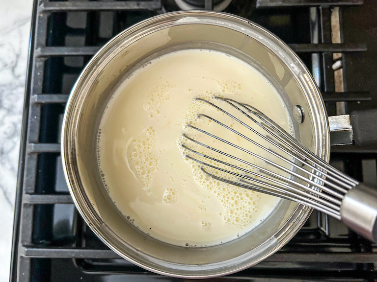 Whisking together ingredients for homemade coconut ice cream