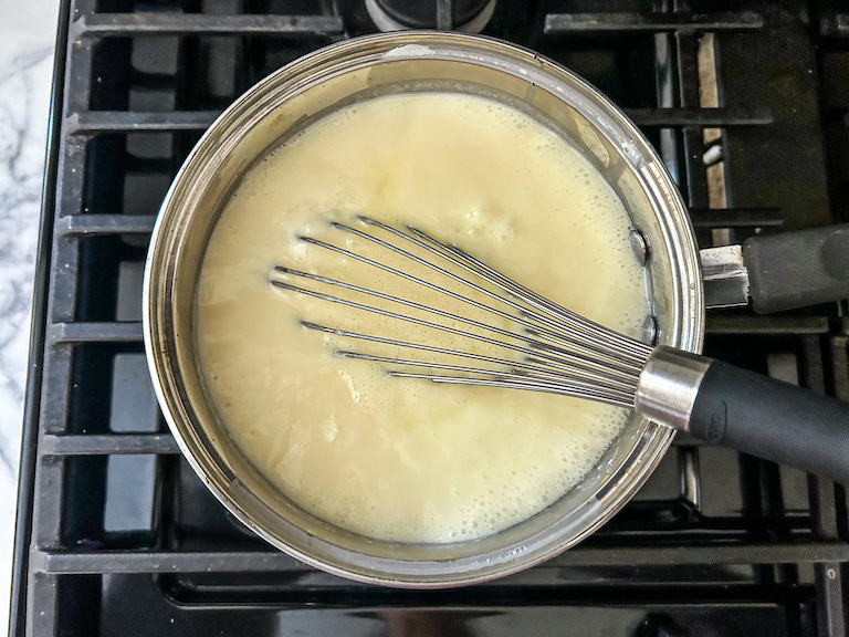 Whisking coconut ice cream in a pan