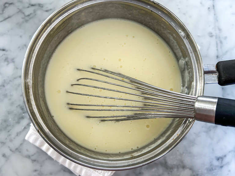 Ice cream base in a pan with a whisk