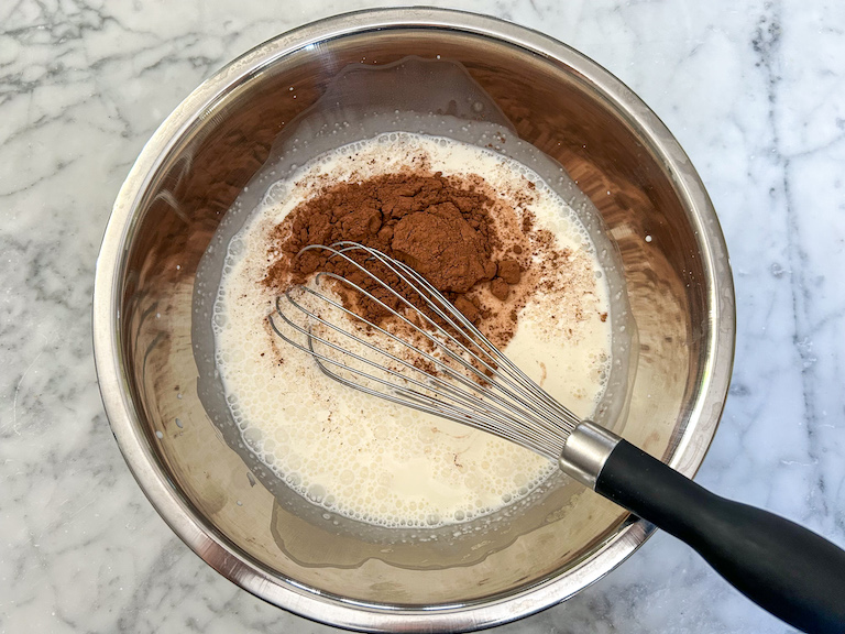 Whisking cocoa powder into ice cream base mixture