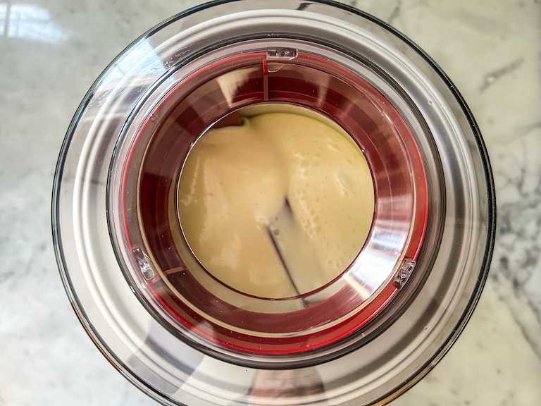 Ice cream maker churning homemade ice cream with coconut