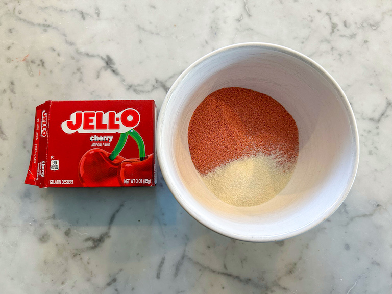 Package of Jello and red gelatin powder in a bowl