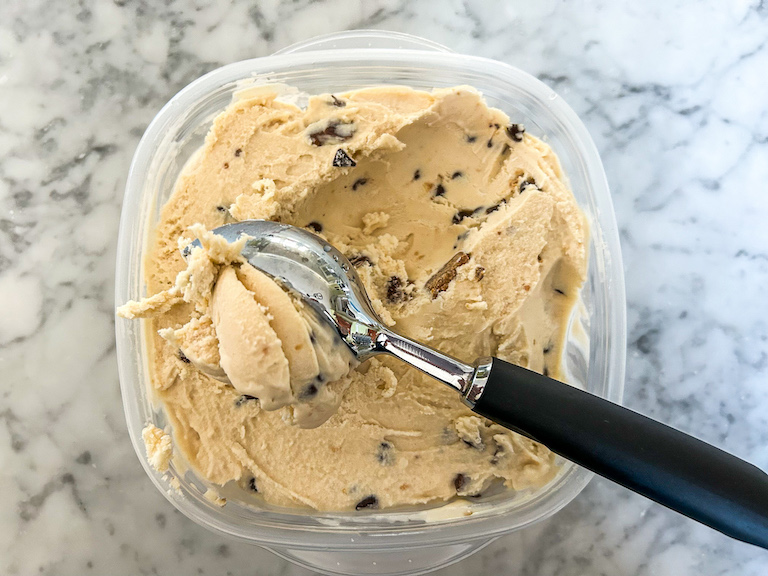 Scooping peanut butter ice cream with an ice cream scoop