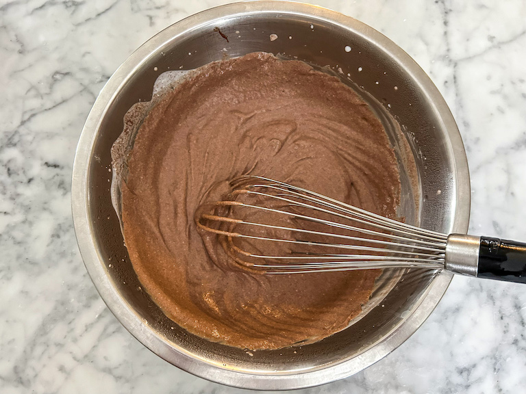 Nutella ice cream base in a bowl with a whisk