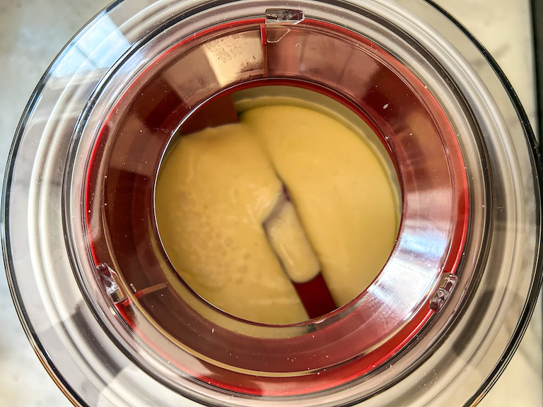 Mango ice cream churning in an ice cream maker