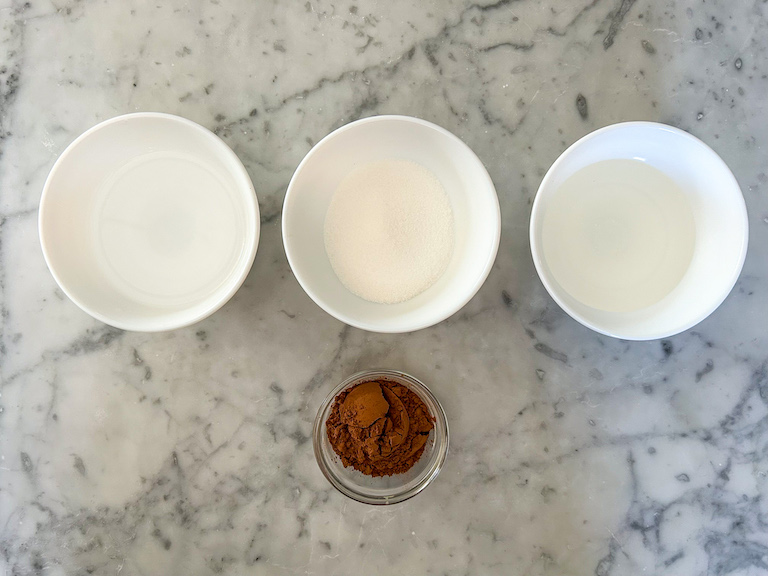 Ingredients for making the fudge sauce arranged on a marble countertop