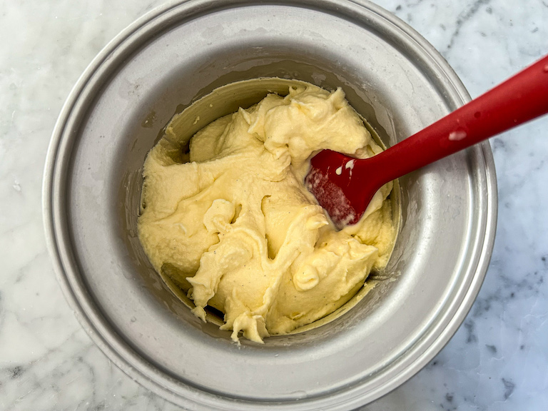 creamy mango ice cream with a rubber spatula