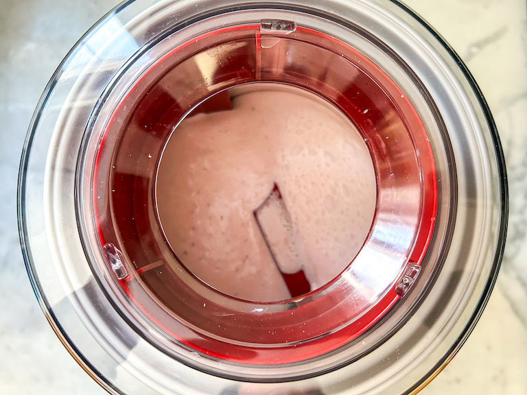 Strawberry ice cream churning in an ice cream maker