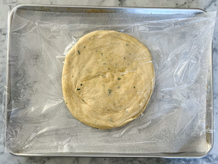 Focaccia dough shaped into a circle