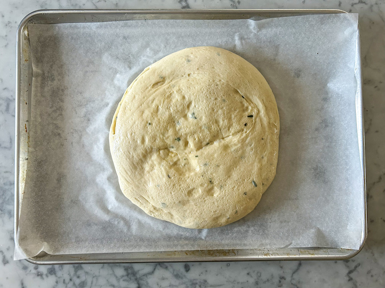 A loaf of apple cheddar focaccia after proving