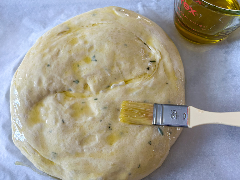 Brushing dough with olive oil