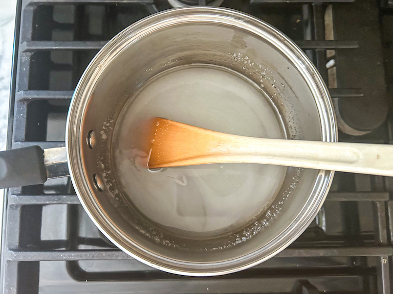 Pan with sugar syrup and a spoon