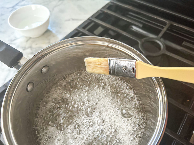 Brushing down pan with water