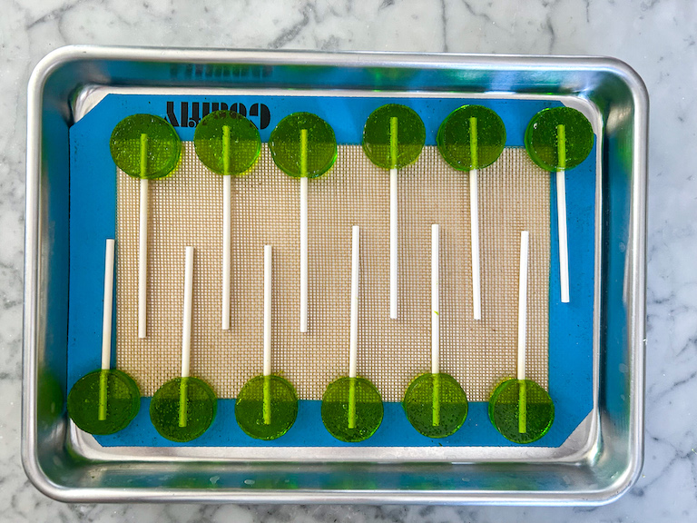 Green apple lollipops on a tray