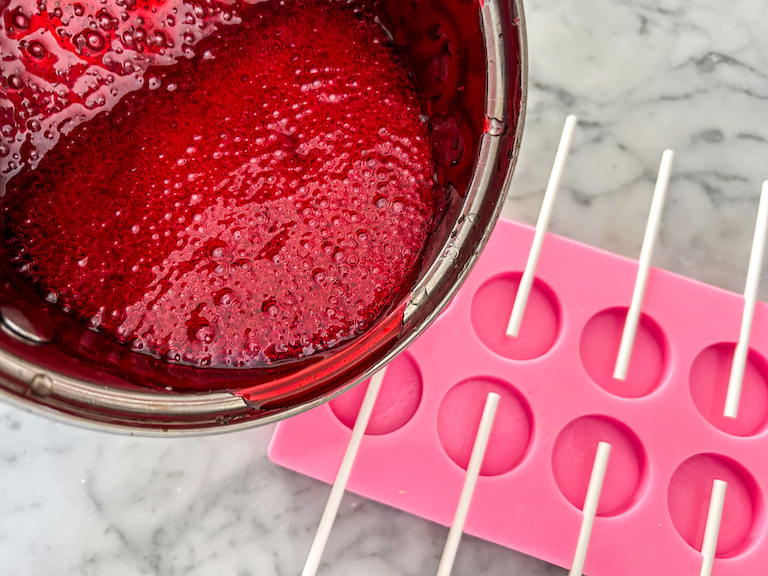 Pouring peppermint syrup into lollipop mould