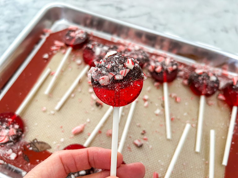 Hand holding a homemade Christmas lollipop