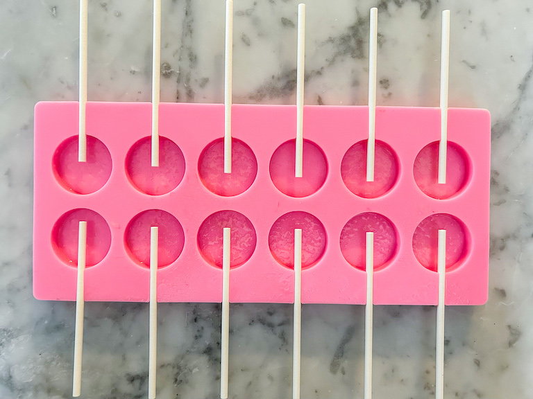 A pink silicone lollipop mold