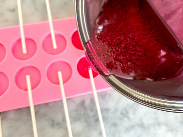 Pouring sugar syrup into lollipop mold