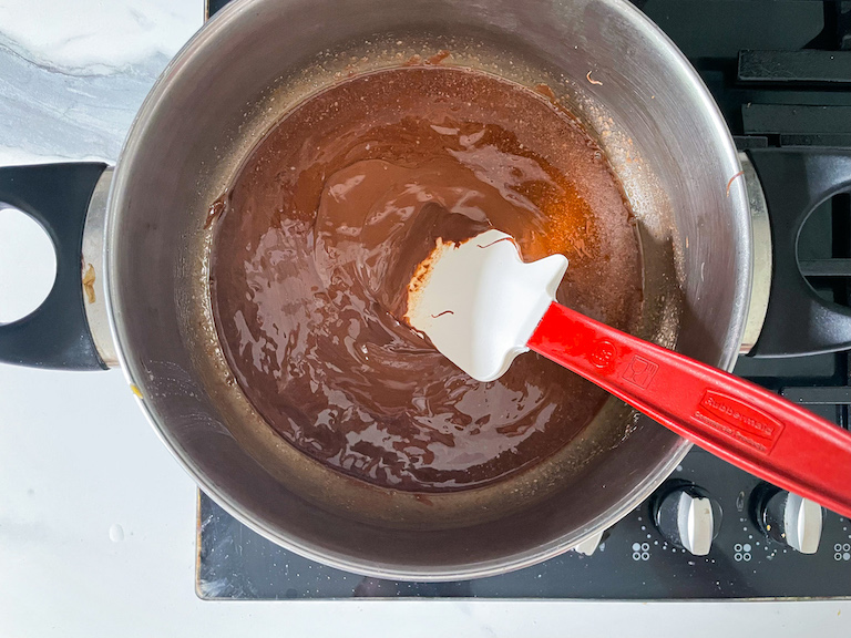 Melted butter and Nutella in a stock pot with a spatula