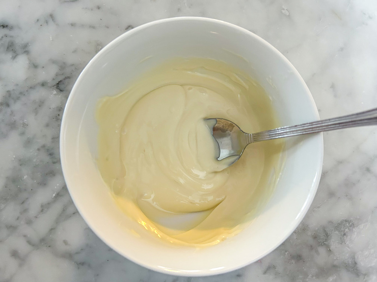 Melted white chocolate in a bowl