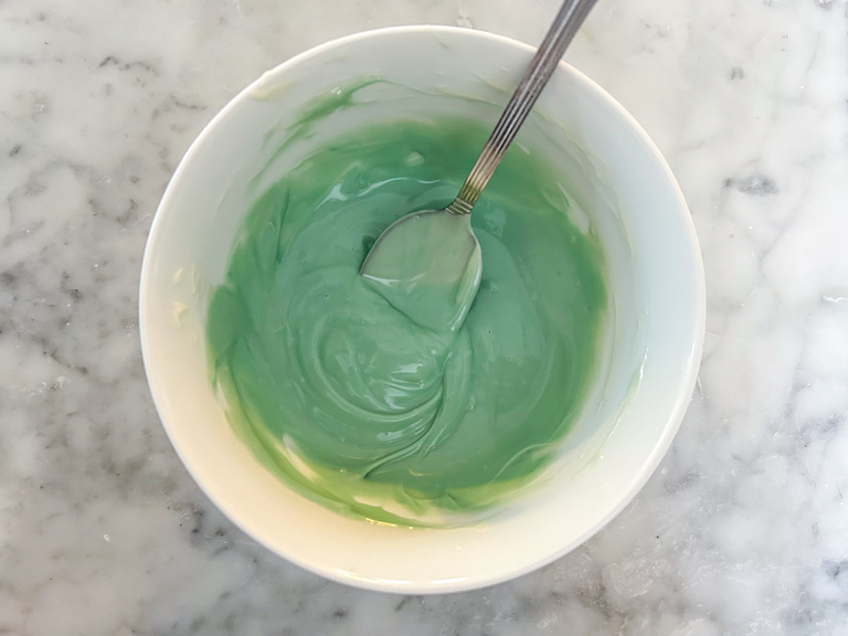 Bowl of green melted chocolate