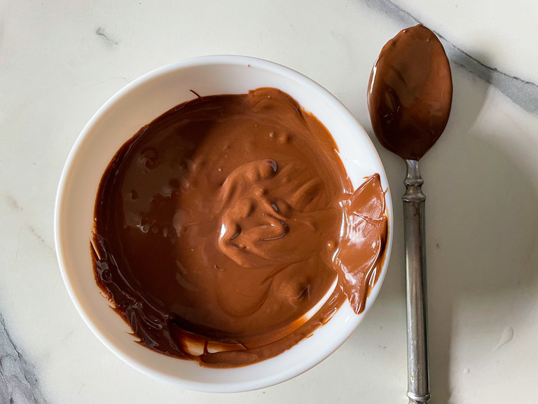 Melted Nutella in a bowl with a spoon