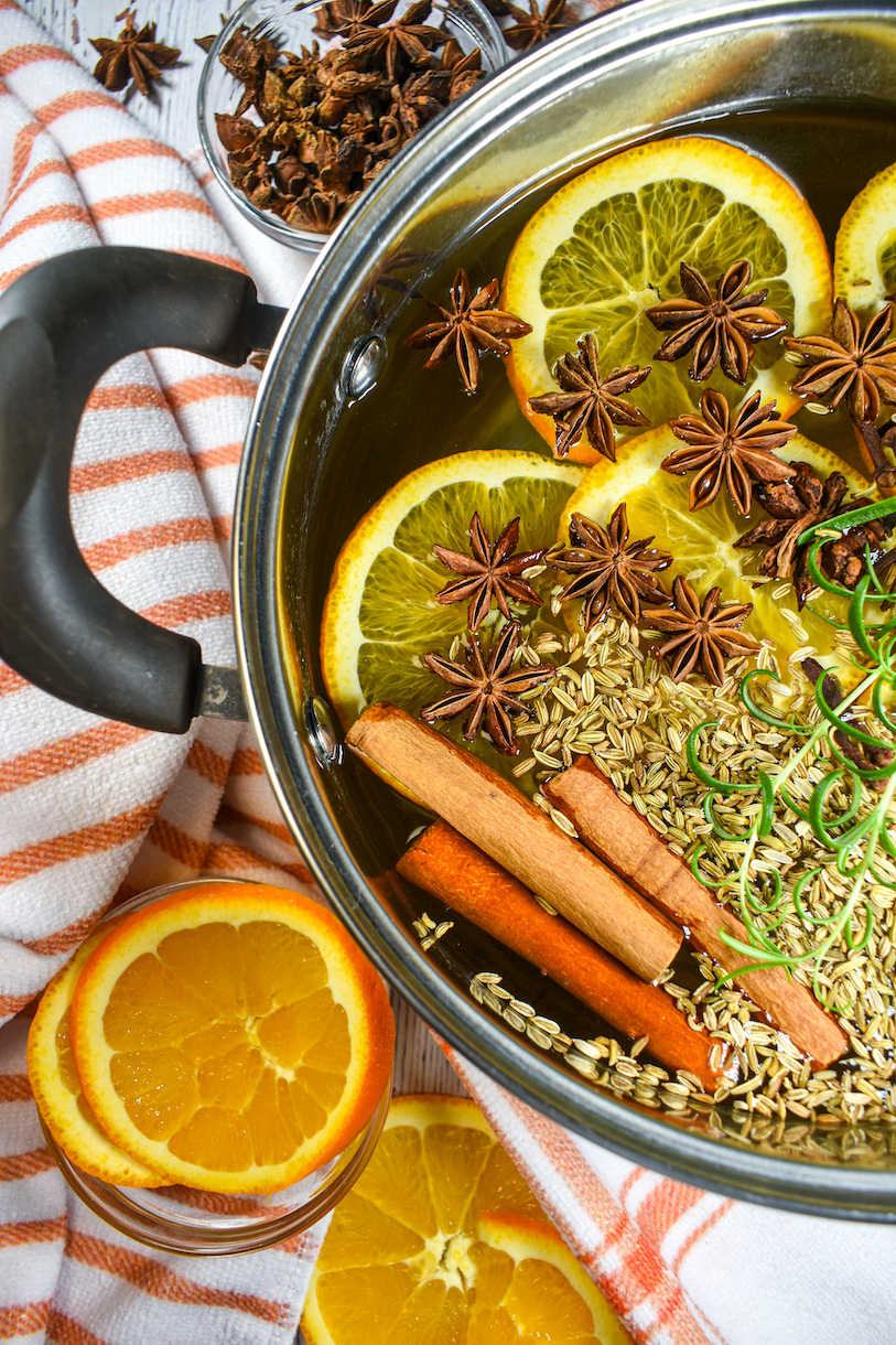 Horizontal shot of orange simmer pot and fresh orange slices