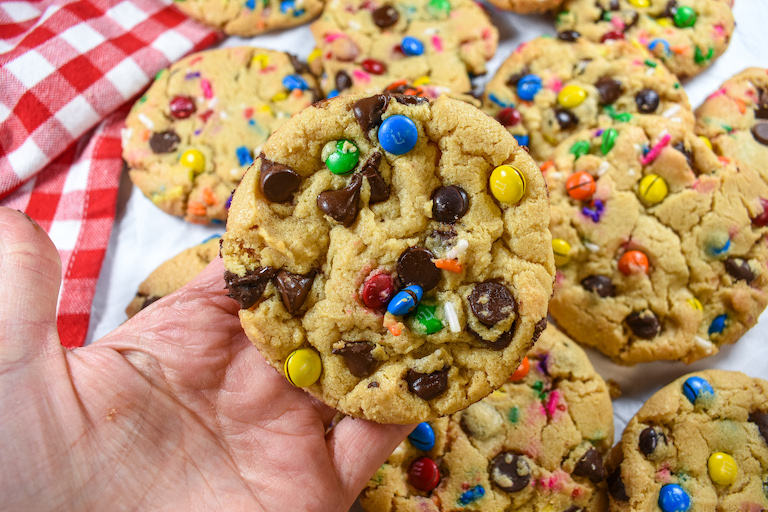 hand holding an M&M cookie