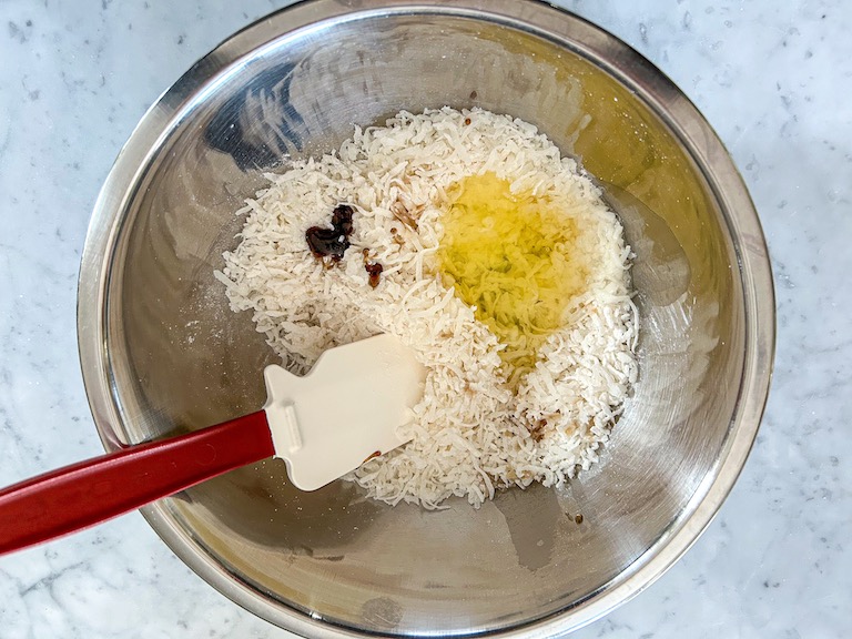 Adding egg whites and vanilla to coconut mixture