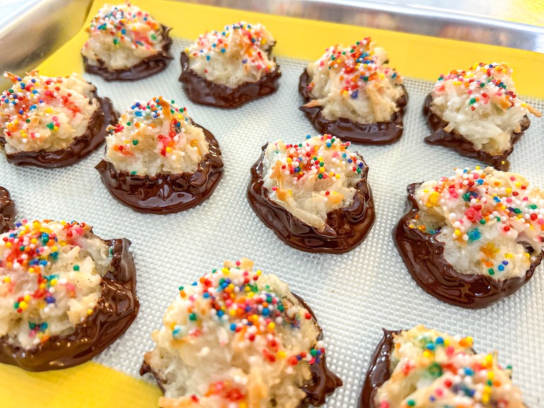 Chocolate dipped coconut macaroons with rainbow sprinkles