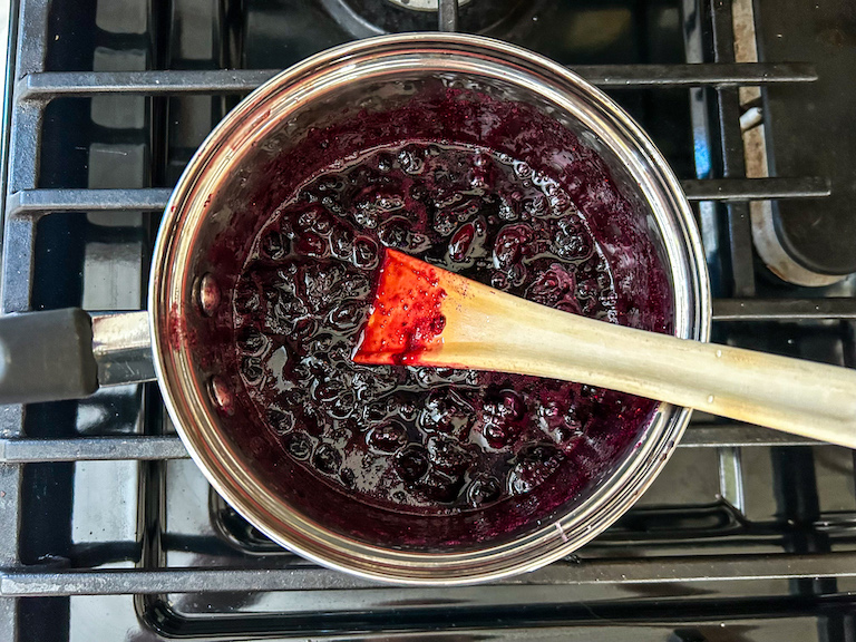 Homemade jam cooking in a saucepan on the stovetop