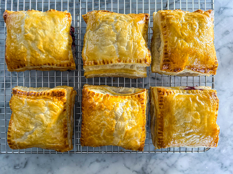 Puff pastry hand pies on a wire rack