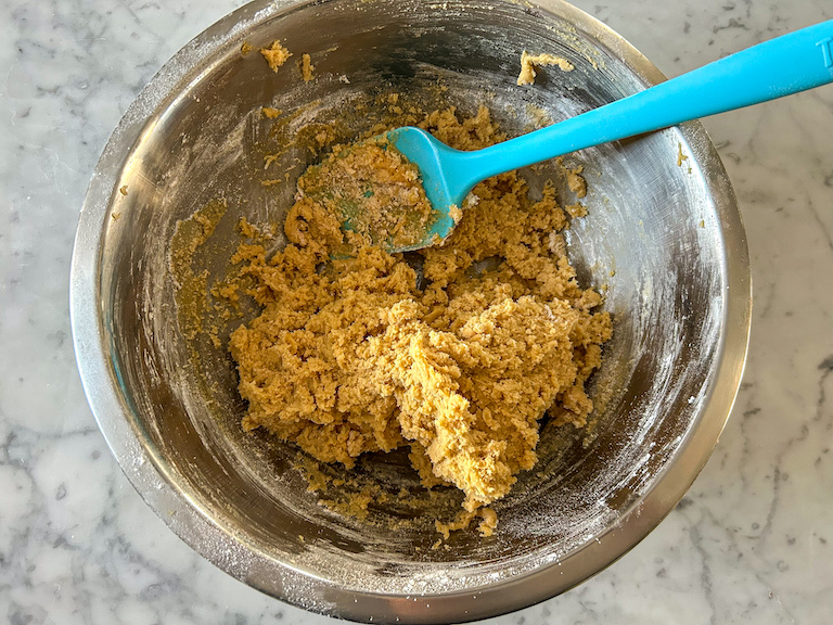 Peanut butter cookie dough in bowl with spatula