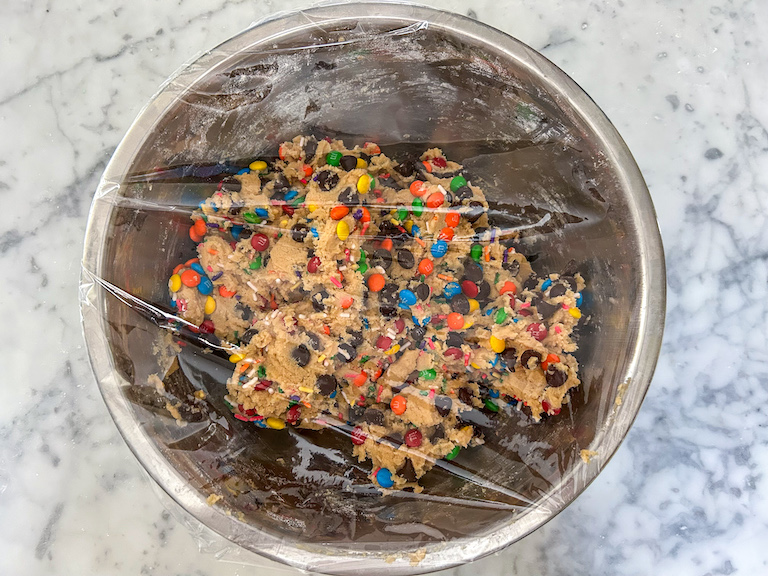 bowl of cookie dough covered in plastic wrap