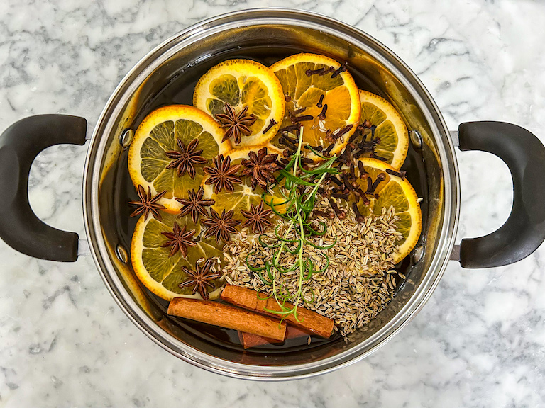 Orange simmer pot on a marble countertop