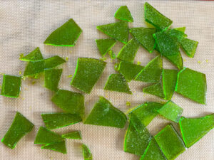 pieces of green hard candy on a silpat mat