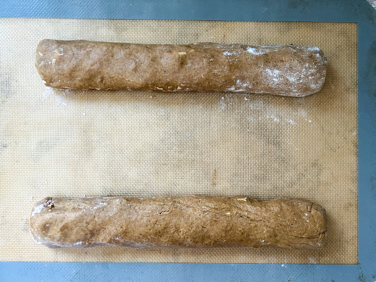 Logs of biscotti dough on a silicone mat