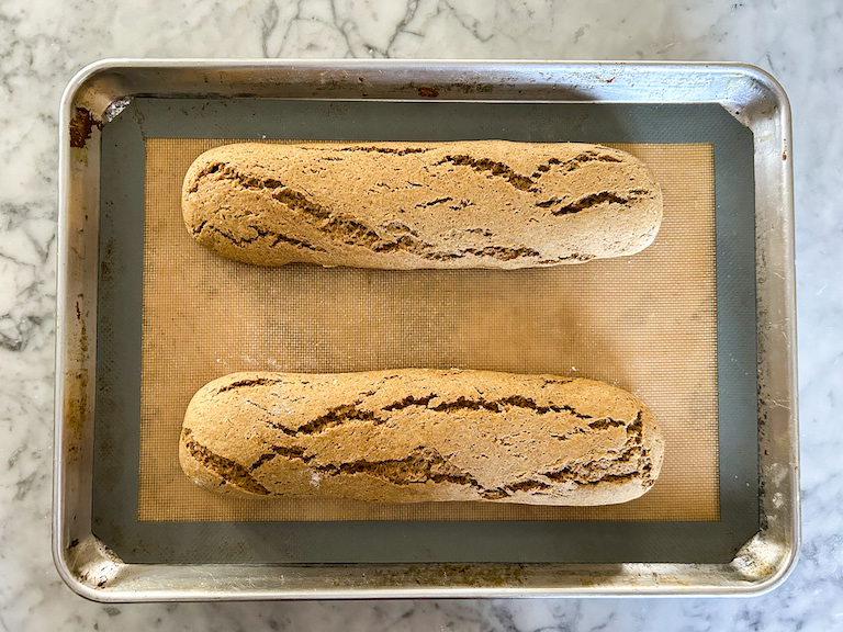 two logs of biscotti on a tray after baking