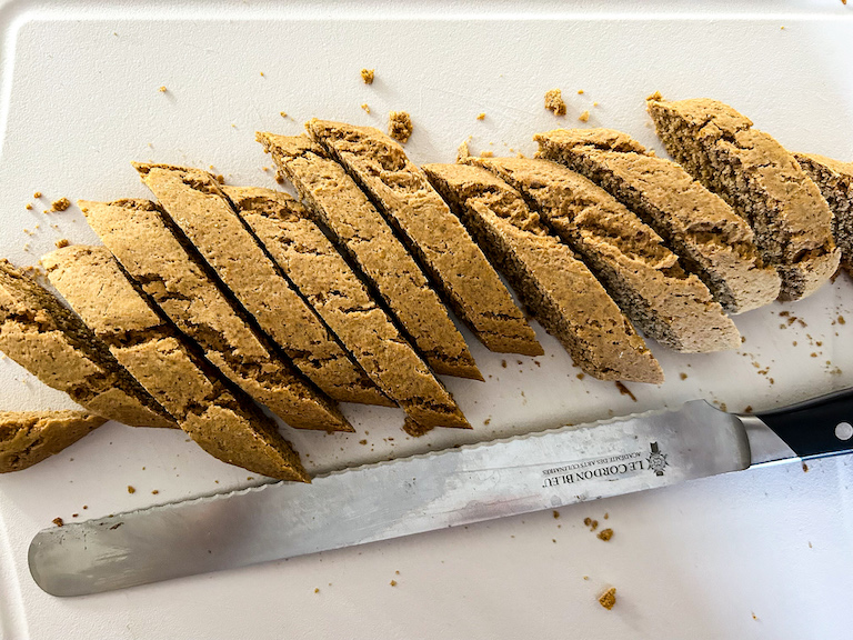 Serrated knife and slices of pumpkin biscotti