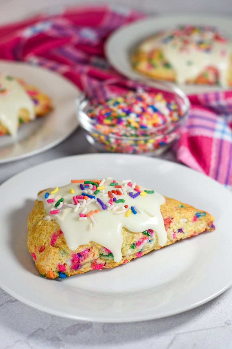 A birthday cake scone on a white plate