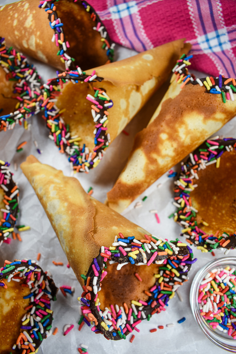 Homemade ice cream cones with chocolate and rainbow sprinkles