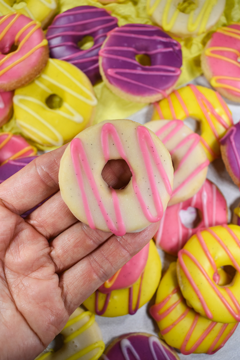 Hand holding pink and white biscuit