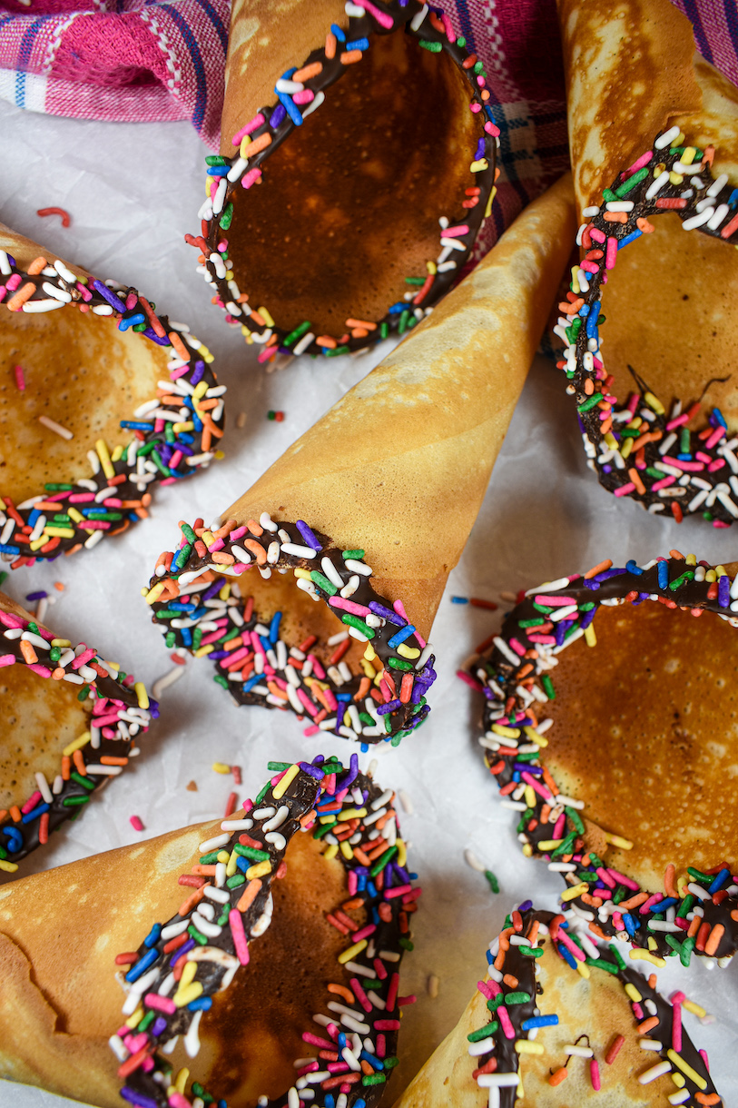 homemade ice cream cones decorated with chocolate and sprinkles