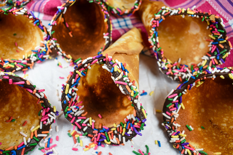 Homemade ice cream cones with chocolate and rainbow sprinkles