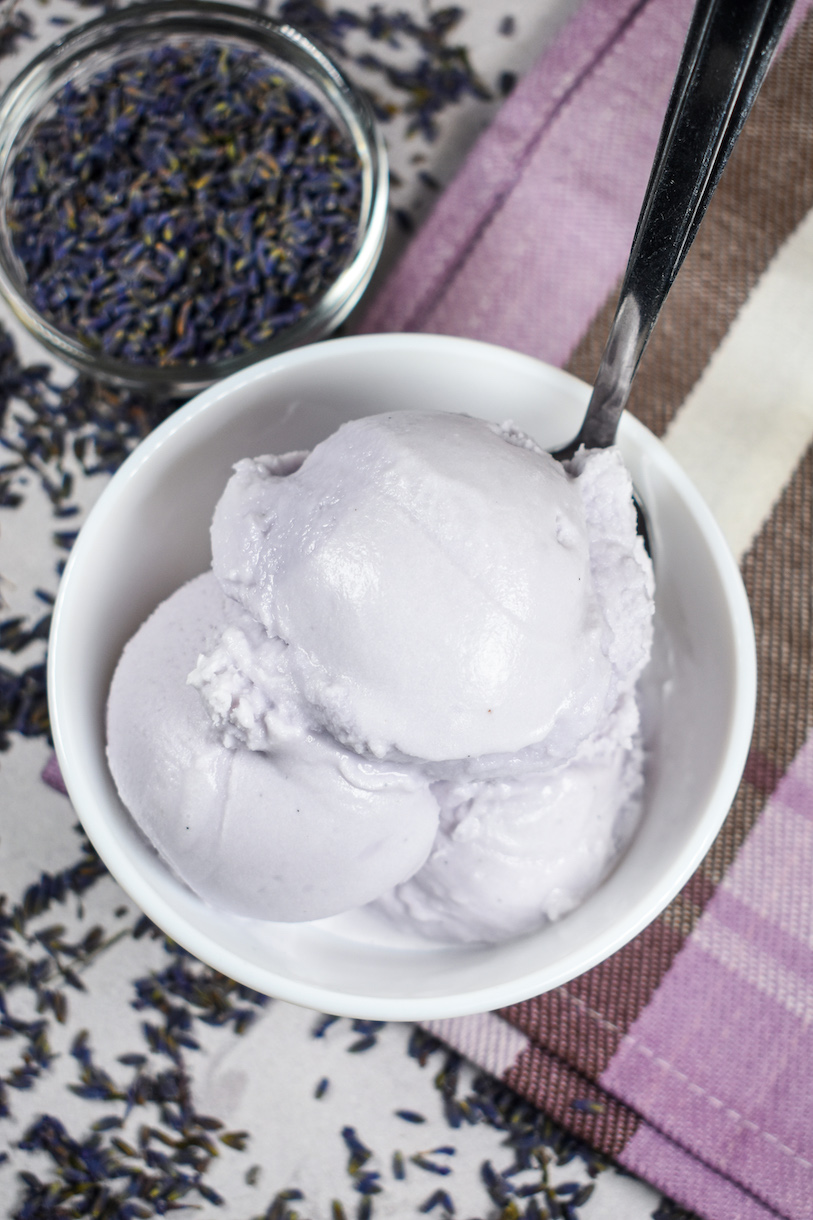 Dish of lavender ice cream and a smaller dish of dried lavender buds