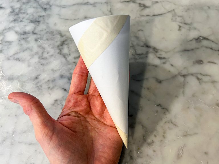 Hand holding cardboard ice cream cone template