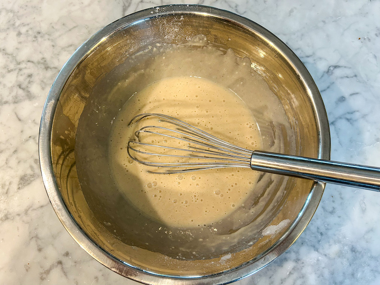 Ice cream cone batter in bowl with whisk